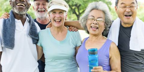 A group of smiling seniors ready to exercise.