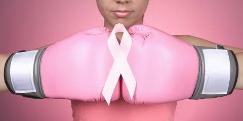 a woman with boxing gloves fighting breast cancer