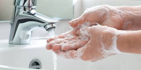 a man washing his hands thoroughly
