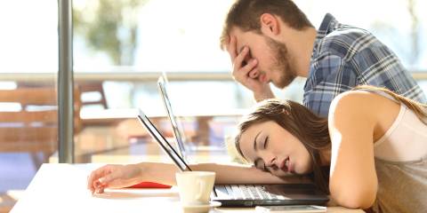 two people trying to work but falling asleep from fatigue
