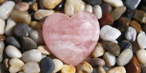 a pebble rock garden with a rose quartz heart