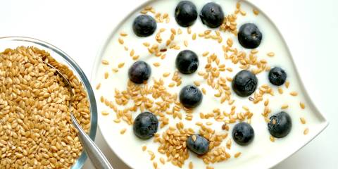 a bowl of yogurt with blueberries and flaxseed