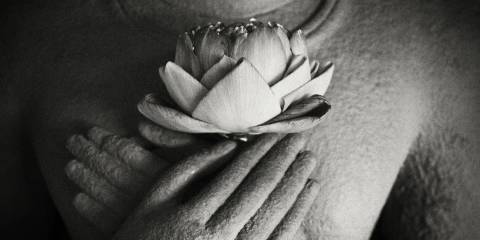 Buddha statue holding lotus flower.