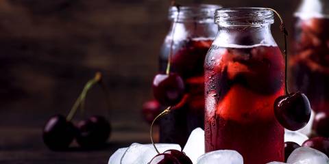 a glass of tart cherry juice and probiotic water