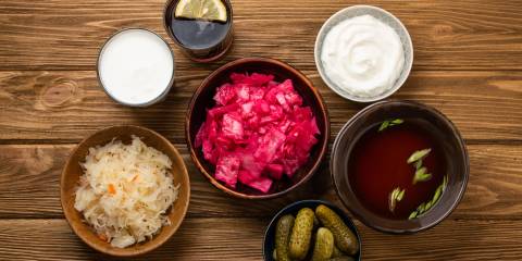 different fermented foods in jars and bowls