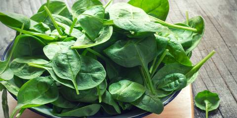 fresh baby spinach piled high in a dish