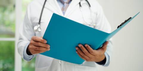 a doctor reading a report on a medical study