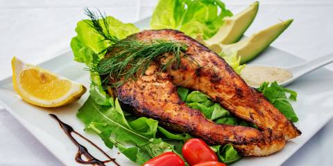 a keto-friendly meal of fish, avocado, and vegetables