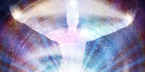 A white figure arms outspread with radiating lines of energy.