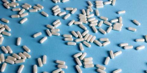 White capsules on a light blue background. 
