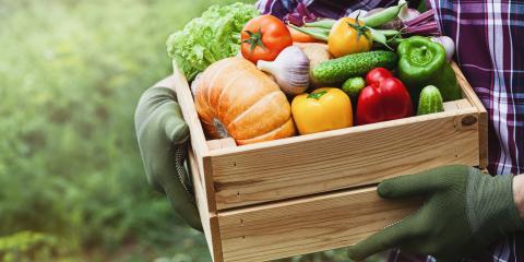 Farmer holding a box of fresh produce