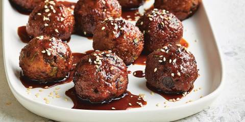 Asian Turkey Meatballs with Sweet Soy Dipping Sauce on a white platter ready to serve.