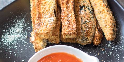 a plate of eggplant fries with marinara for dipping