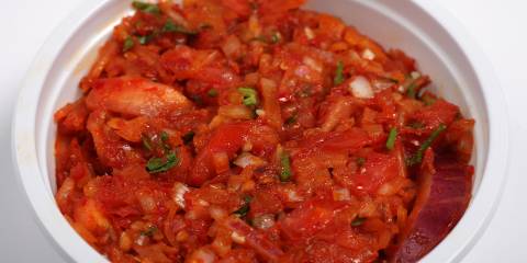 a bowl of blended tomatoes, shallot, and peppers