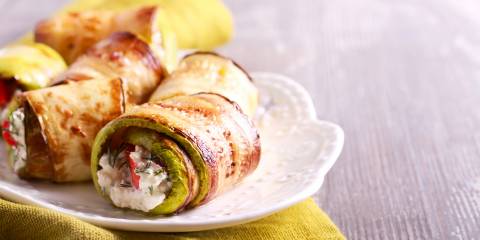 Zucchini Rolls on a white plate ready to enjoy.