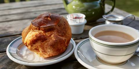 fresh-baked popovers served with berry jam and a pot of tea
