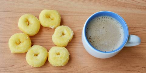 Miniature donuts next to a cup of coffee