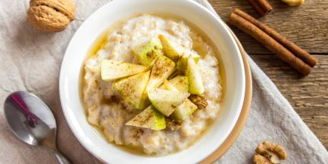 Bowl of oatmeal with cinnamon and walnuts. 