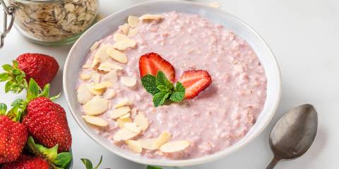 a bowl of strawberry oatmeal with almonds