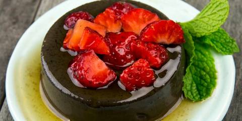 a delicious plate of flan with fruit on top