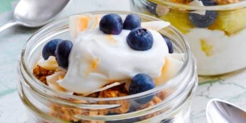blueberries, pineapple, granola, and yogurt served in small jars