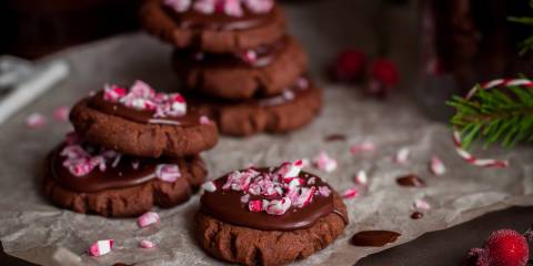 a plate of chocolate cookies with crushed candy canes