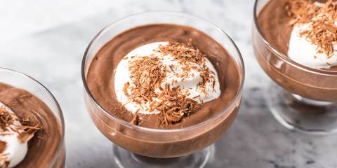 dishes of chocolate mousse with cream and shavings