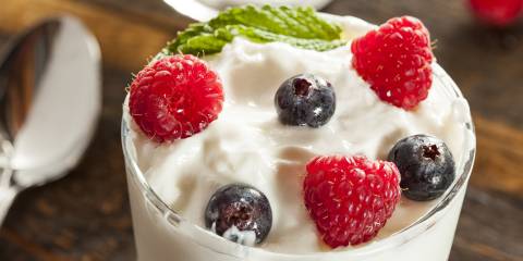 a close-up of a creamy parfait topped with berries