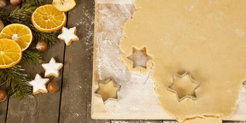 Christmas cookies in the shape of stars are gouged, beside decoration.