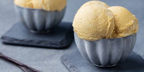 Homemade French Vanilla Ice Cream scooped into two blue bowls.