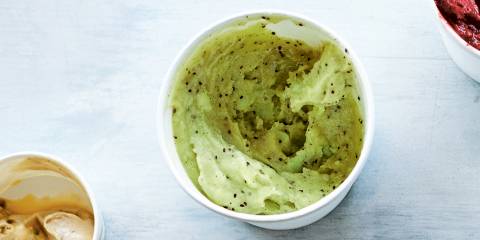 a cup of smooth light green sorbet with seeds