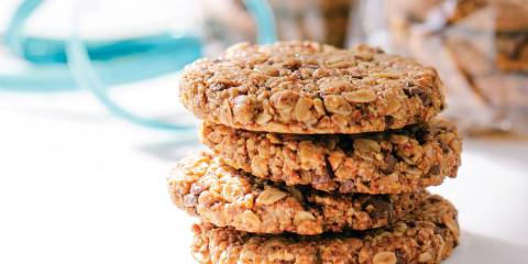 A stack of granola cookies with chocolate and nuts