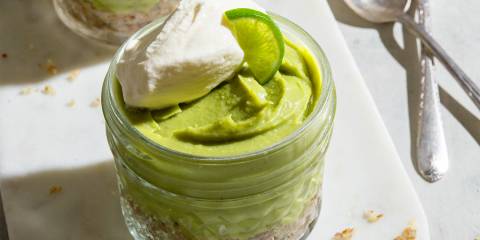 a small mason jar lined with nuts and filled with key lime pie filling