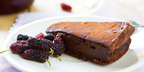 Chocolate truffle torte by berries and tea.