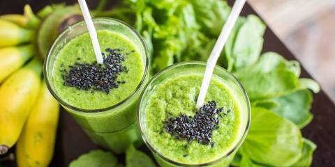 a green smoothie with spinach, bananas, and sesame seeds