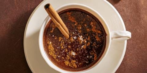 a mug of hot cocoa with a cinnamon stick