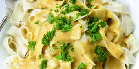 A plate of artichoke ribbon pasta with curry sauce