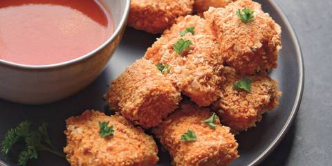 breaded chicken served with red dipping sauce
