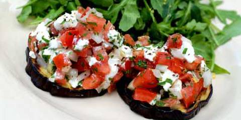 slices of eggplant with tomato and goat cheese on top