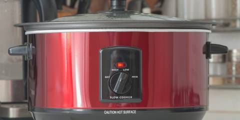 A slow cooker in use on a kitchen counter top.