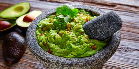 guacamole sauce served in a traditional stone bowl