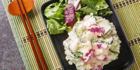 chopsticks and a bowl of mashed potatoes and vegetables