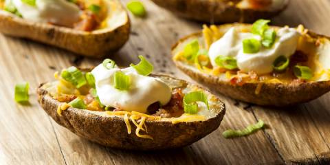baked potato skins with cheese, bacon, sour cream, and scallions