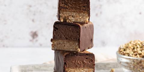 a stack of crunchy mousse bars enrobed in chocolate
