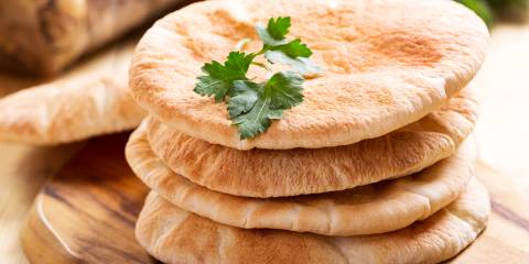 Four pieces of pita bread in a stack. 