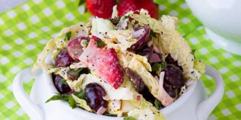 a dish of coleslaw with berries and seeds