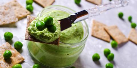 A jar of sweet green pea dip, with crackers