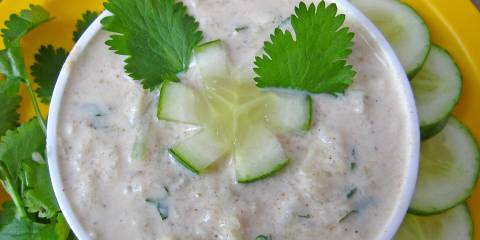 a bowl of Indian spiced yogurt with cucumber