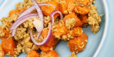 A plate of sweet potato scramble with red onion on top