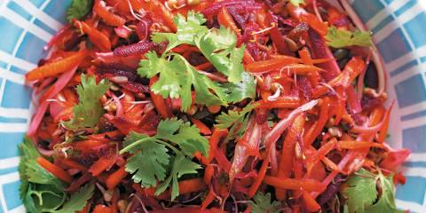 a bowl of salad with carrots, beetroots, and fennel